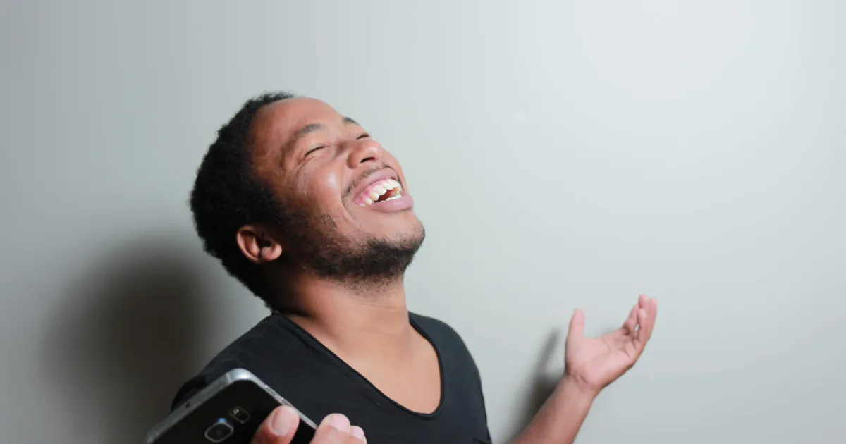 Happy person with a smartphone after getting a no credit check loan in Canada