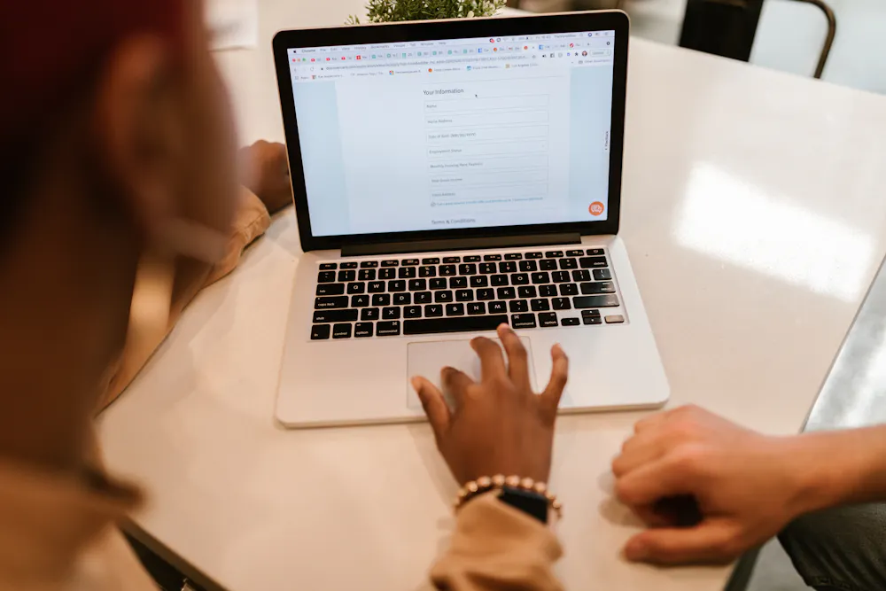 Filling out a $300 no credit check loan application on a laptop in Canada