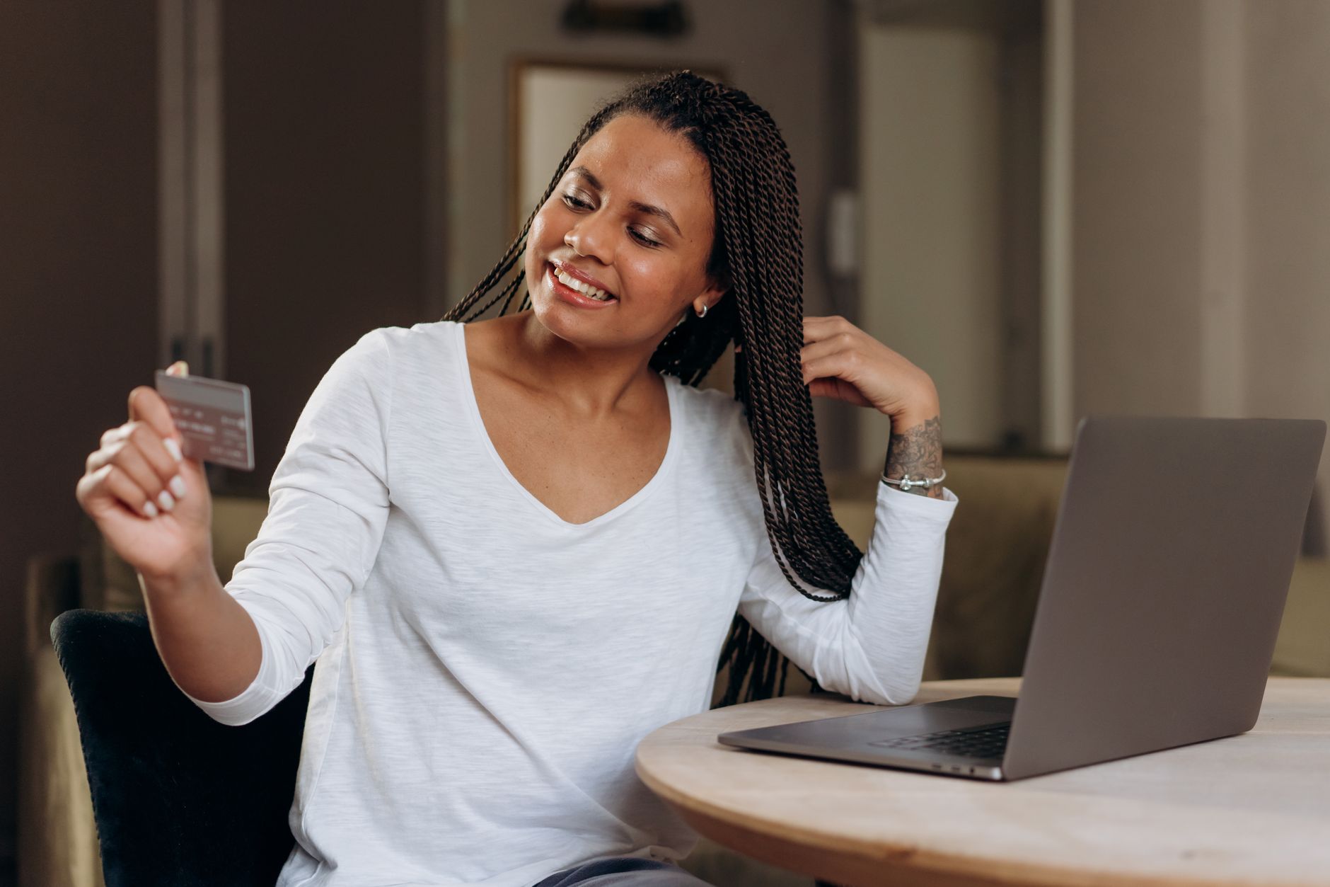 Woman completing online credit card transaction for loan application Canada