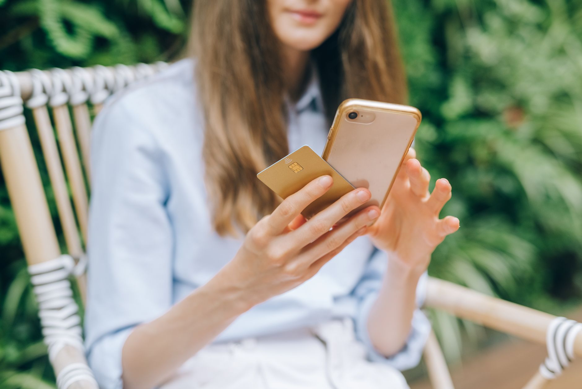 Woman making online payment with smartphone - $100 no credit check loan Canada