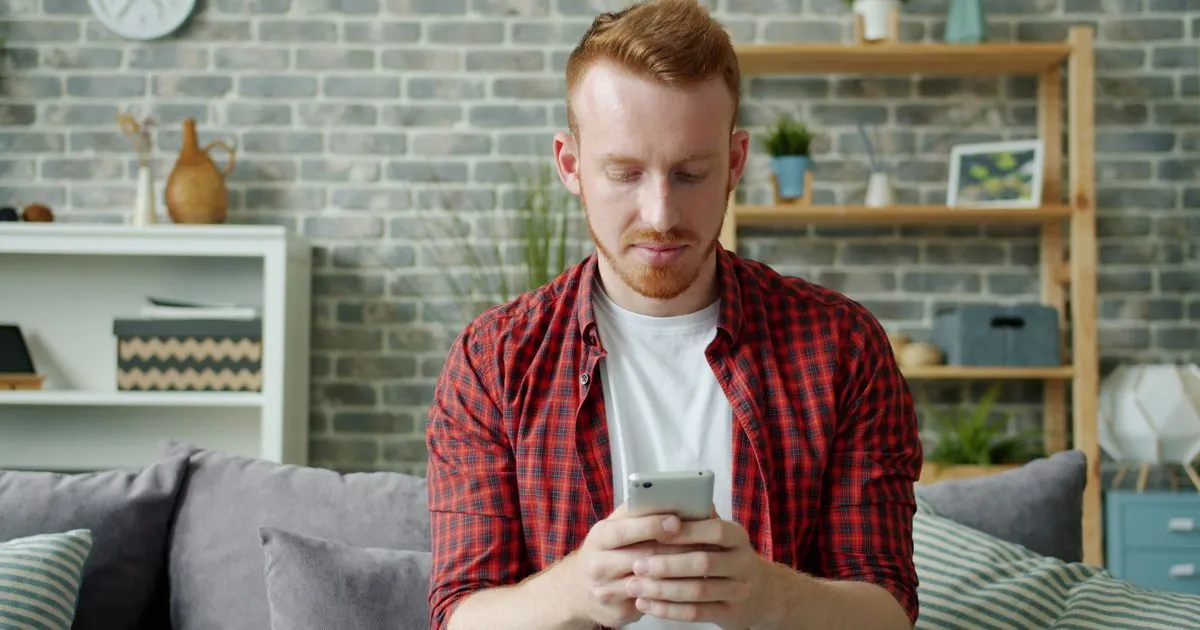 Borrower approved for a $1500 no credit check loan checking the e-Transfer on his phone