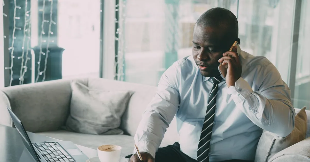 Confirming an instant loan decision by phone with a laptop open