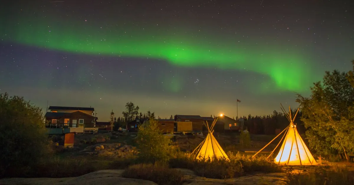 Instant loans Northwest Territories residents get online, with the aurora over glowing tipis near Yellowknife