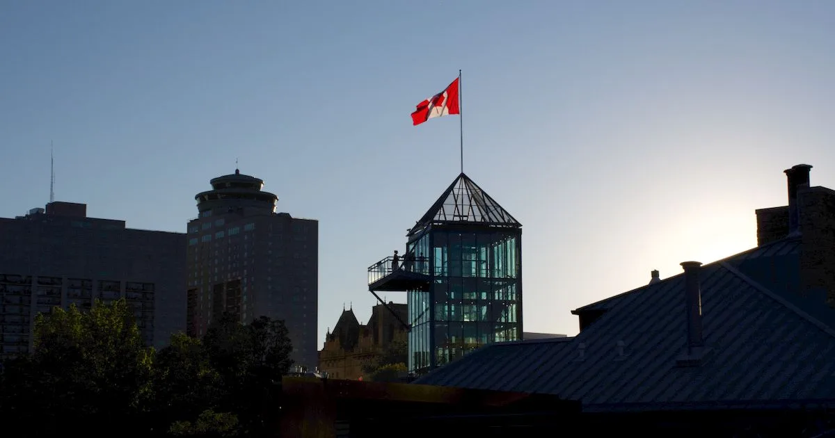 Instant loans Winnipeg - The Forks tower with a Canadian flag at sunset in downtown Winnipeg