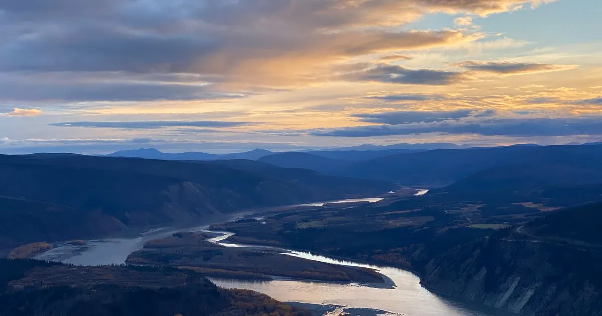 Instant loans Yukon residents apply for online, with the Yukon River winding past Dawson City at sunset
