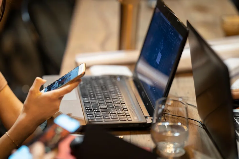 Applying online for an instant loan with a phone and laptop