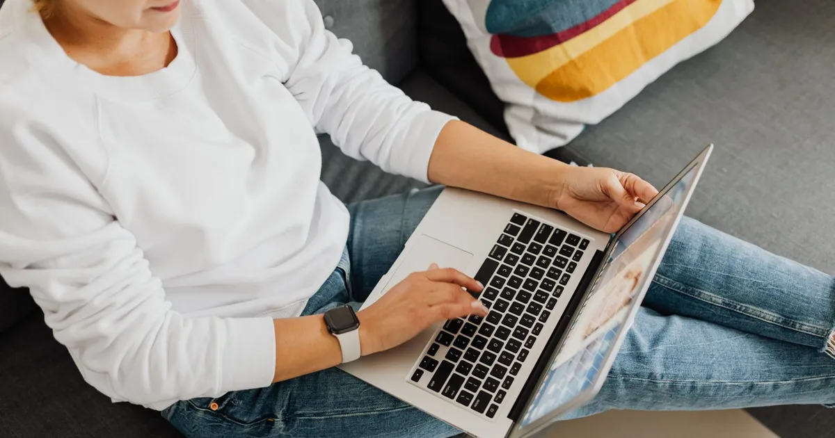 Woman applying for no credit check installment loans on a laptop from her sofa in Canada