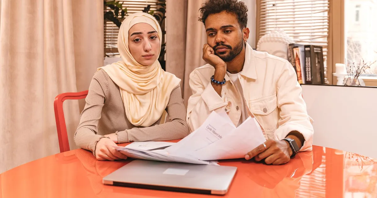 Couple reviewing old statements before applying for no credit check installment loans